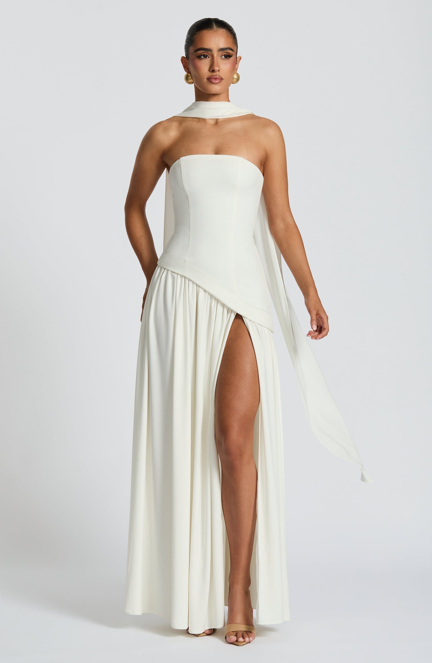 White strapless satin maxi dress with high slit and sculpted waist